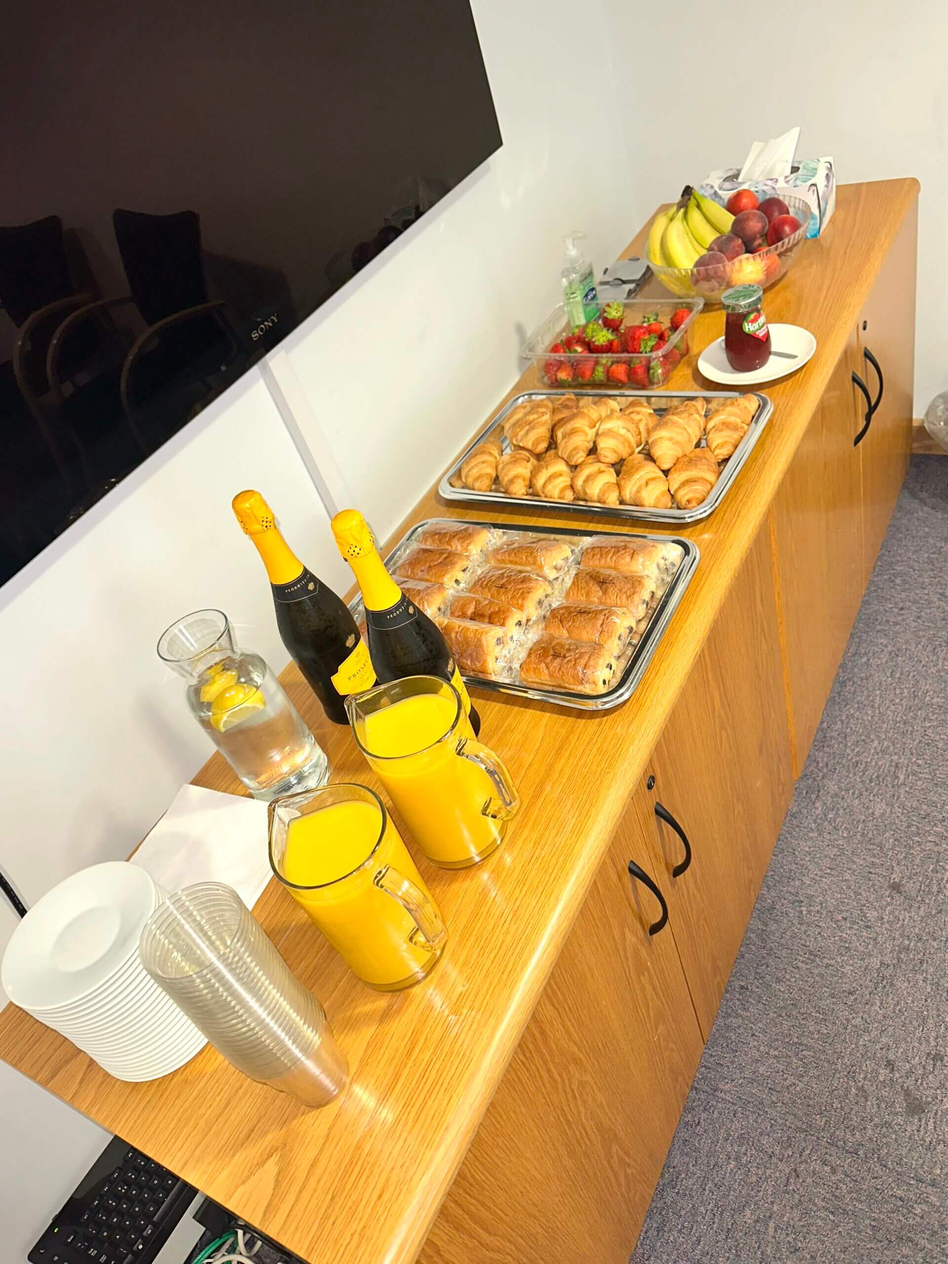 A selection of drinks, pastries and fruit