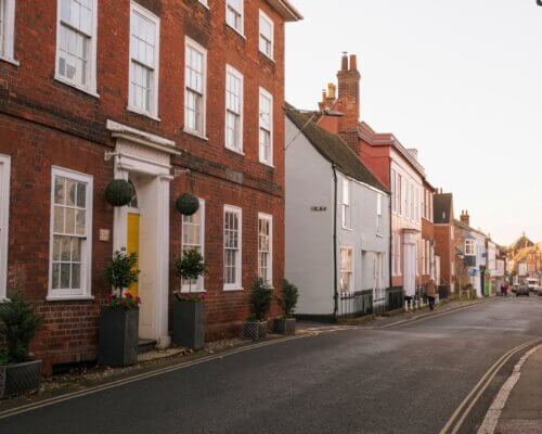 A picture of a small village street lined with houses and shops