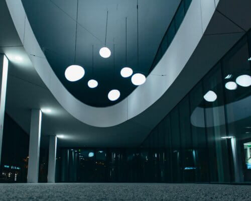 A picture of an office with bright lights and windows