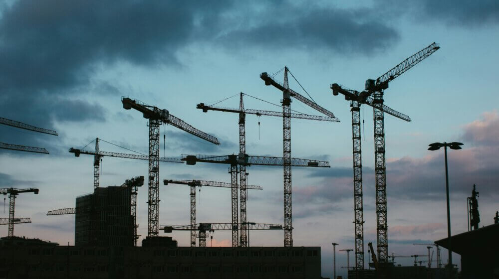 A picture of a skyline at sunset with construction building works in view