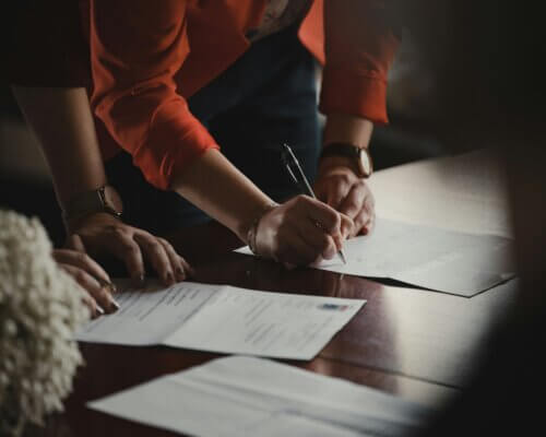 People signing business contract