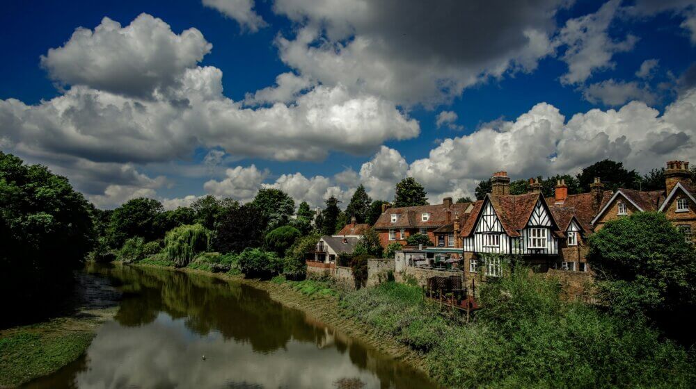 picture of hertfordshire town buildings along a river on a sunny day